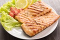 Grilled salmon with lemon,tomato on the wooden table Royalty Free Stock Photo