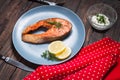 Grilled salmon with lemon on wooden background