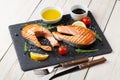 Grilled salmon, salad and condiments Royalty Free Stock Photo