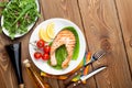 Grilled salmon, salad and condiments Royalty Free Stock Photo