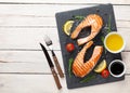 Grilled salmon, salad and condiments on wooden table Royalty Free Stock Photo