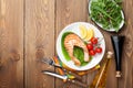 Grilled salmon, salad and condiments on wooden table Royalty Free Stock Photo