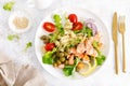 Grilled salmon salad with fresh lettuce, tomatoes, green olives, red onion and pasta. Healthy food, diet. Top view Royalty Free Stock Photo