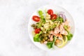 Grilled salmon salad with fresh lettuce, tomatoes, green olives, red onion and pasta. Healthy food, diet. Top view Royalty Free Stock Photo
