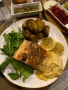 Grilled salmon with sliced lemon, arugula and sweet potato on a plate. Royalty Free Stock Photo