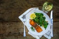 grilled salmon with spinach an wine on a dark rustic wooden table, view from above, copy space Royalty Free Stock Photo