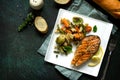 Grilled salmon steak, couscous and vegetables on stone or concrete table. Healthy proper nutrition. Royalty Free Stock Photo