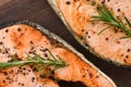 Grilled salmon steak with herbs and spices rosemary lemon on wooden background - Close up cooked salmon fish fillet steak seafood Royalty Free Stock Photo