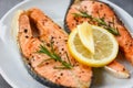 Grilled salmon steak with herbs and spices rosemary on plate background - Close up cooked salmon fish fillet steak seafood Royalty Free Stock Photo