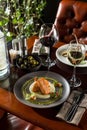 Grilled salmon steak with mashed potato and glass of white wine on wooden table at restaurant Royalty Free Stock Photo