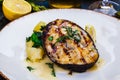 Grilled salmon steak with potato and spinach on white plate Royalty Free Stock Photo