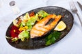 Grilled salmon steak with vegetable salad Royalty Free Stock Photo