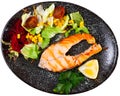 Grilled salmon steak with vegetable salad Royalty Free Stock Photo