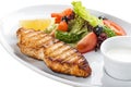 Grilled salmon steak with vegetables. On a white plate Royalty Free Stock Photo