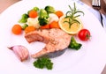 Grilled salmon steak with vegetables on white plate Royalty Free Stock Photo