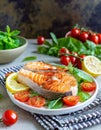 Grilled salmon steaks on a plate with salad.