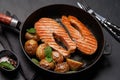 Grilled salmon steaks and potatoes in a frying pan Royalty Free Stock Photo