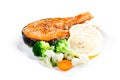 Grilled salmon with steamed vegetables on plate isolated on whit Royalty Free Stock Photo