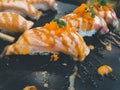 Grilled salmon sushi topped with sweet sauce and shrimp eggs Royalty Free Stock Photo