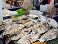 Grilled salt crusted whole body fish fill Thai herbs inside in street food, Thailand Royalty Free Stock Photo