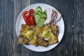 Grilled sandwich with egg, vegetables and bacon on a dark wooden background. Tasty breakfast Royalty Free Stock Photo