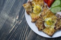 Grilled sandwich with egg, vegetables and bacon on a dark wooden background. Tasty breakfast Royalty Free Stock Photo