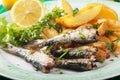 Grilled sardine fish with potato wedges Royalty Free Stock Photo