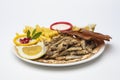 Grilled Sardines plate served with sauce on white