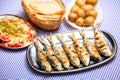 Grilled sardines with salad, bread and potato