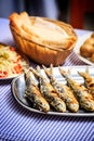 Grilled sardines with salad, bread and potato
