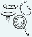 Grilled sausage on fork and on frying pan Royalty Free Stock Photo