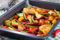 Grilled sausage with garlic, potato, cherry tomatoes, green beans, top-view Royalty Free Stock Photo