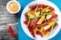 Grilled sausage with garlic, potato, cherry tomatoes, green beans, top-view Royalty Free Stock Photo