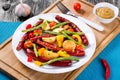 Grilled sausage with garlic, potato, cherry tomatoes, green beans, top-view Royalty Free Stock Photo