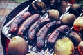 Grilled sausage and potaoes, barbecue Royalty Free Stock Photo