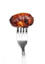 Grilled sausage is pricked on a fork. Royalty Free Stock Photo