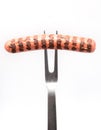 Grilled sausage pricked on fork Royalty Free Stock Photo