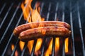 Grilled sausage sizzling over open flame on the barbecue