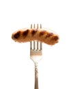 Grilled sausage on vintage fork isolated on white Royalty Free Stock Photo