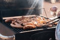 Grilled sausages or bratwurst on grill with smoke and flame Royalty Free Stock Photo