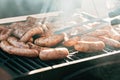 Grilled sausages or bratwurst on grill with smoke and flame Royalty Free Stock Photo