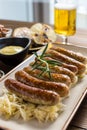Grilled Sausages with Cabbage Salad, Mustard and Beer. Bratwurst and Sauerkraut.