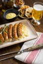 Grilled Sausages with Cabbage Salad, Mustard and Beer. Bratwurst and Sauerkraut.