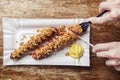 Grilled sausages closeup. The meat dish is sprinkled with dried caramelized onions. Top with grated cheese, mustard and ketchup. Royalty Free Stock Photo