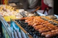 Grilled sausages. Closeup of sausage prepared on stones at China market. Chinese street food Royalty Free Stock Photo