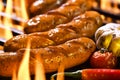 Grilled sausages on the flaming grill Royalty Free Stock Photo