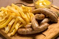 Grilled sausages with french fries with ketchup and mustard Royalty Free Stock Photo