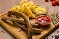 Grilled sausages with french fries with ketchup and mustard Royalty Free Stock Photo