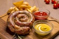 Grilled sausages with french fries with ketchup and mustard Royalty Free Stock Photo