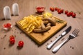 Grilled sausages with french fries with ketchup and mustard on a wooden stand Royalty Free Stock Photo